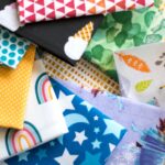 A pile of different colored fabrics on top of each other